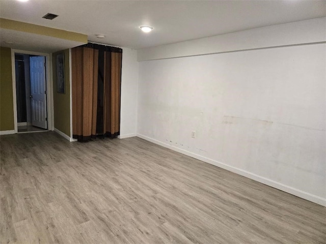 unfurnished room featuring hardwood / wood-style flooring