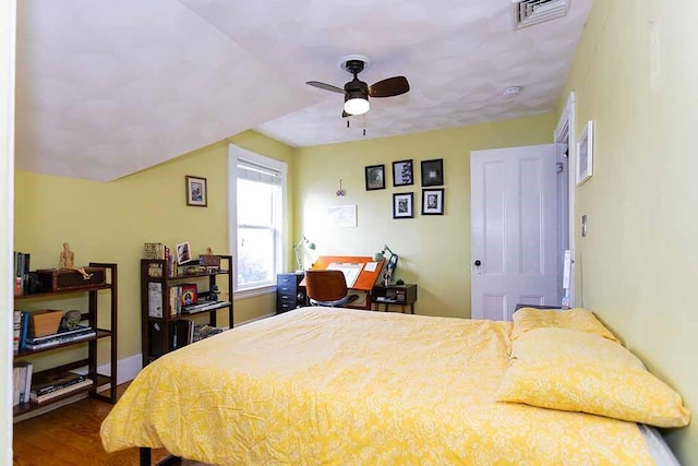 bedroom with hardwood / wood-style flooring, vaulted ceiling, and ceiling fan