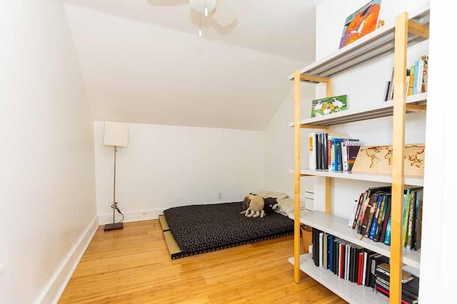 bedroom featuring vaulted ceiling and hardwood / wood-style flooring