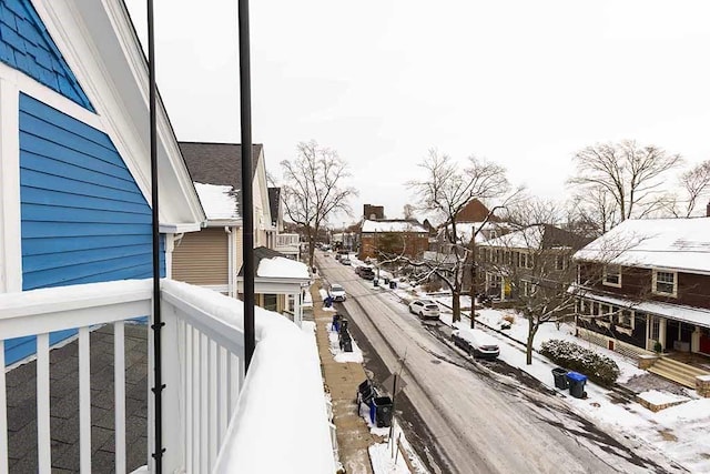 view of snow covered back of property