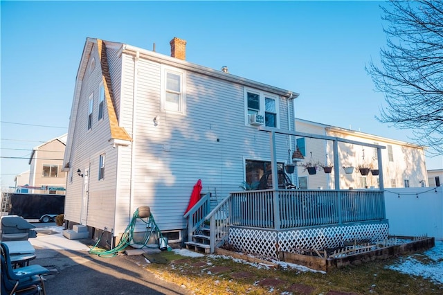 back of property featuring a deck