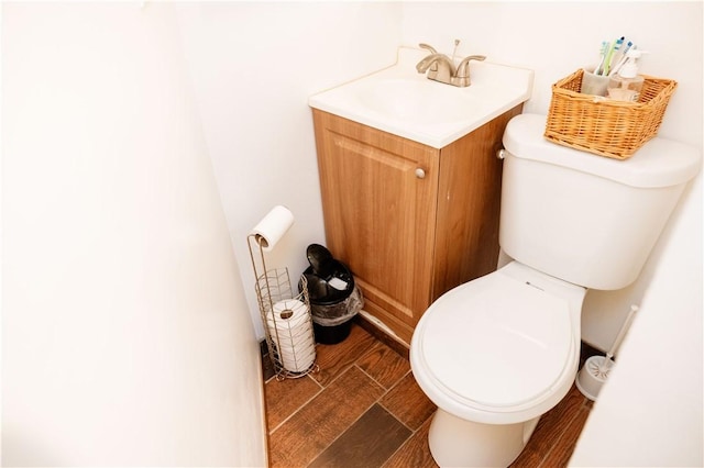 bathroom featuring toilet and vanity