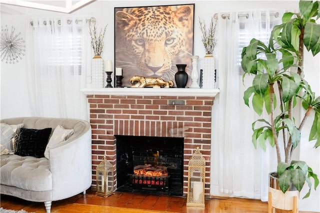 sitting room with hardwood / wood-style flooring and a fireplace