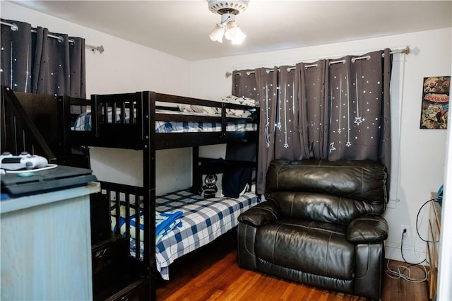 bedroom with dark hardwood / wood-style floors