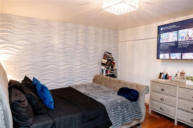 bedroom featuring dark wood-type flooring and a closet