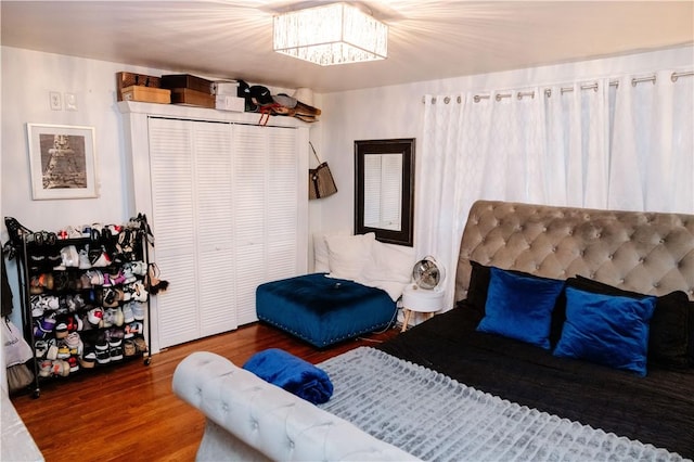 bedroom featuring hardwood / wood-style floors and a closet