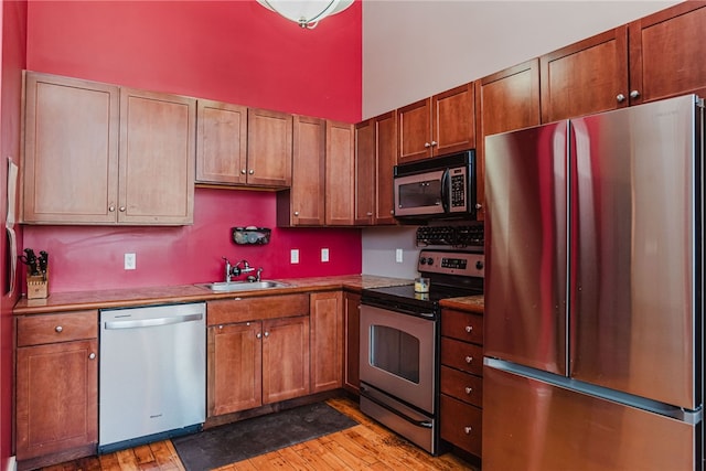 kitchen featuring light hardwood / wood-style floors, sink, and appliances with stainless steel finishes