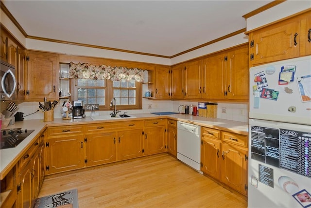 kitchen with sink, white appliances, decorative backsplash, and light wood-type flooring