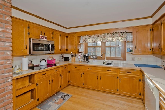 kitchen featuring sink, light wood-type flooring, dishwasher, and tasteful backsplash