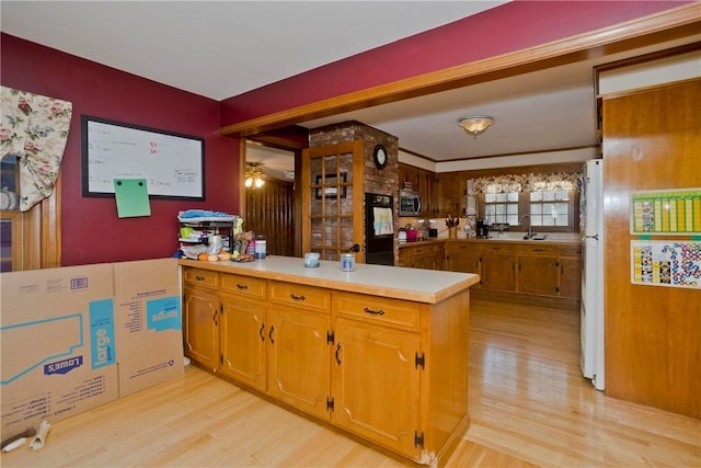 kitchen featuring refrigerator, light hardwood / wood-style floors, sink, kitchen peninsula, and white refrigerator