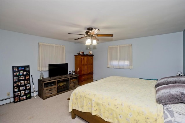 carpeted bedroom featuring ceiling fan and baseboard heating