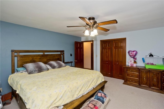 bedroom featuring light colored carpet, a closet, and ceiling fan