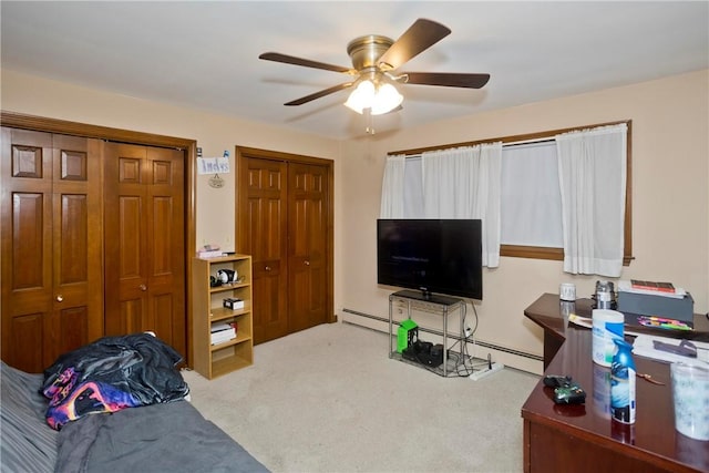 interior space with ceiling fan and two closets