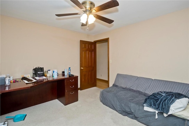 carpeted office space featuring ceiling fan