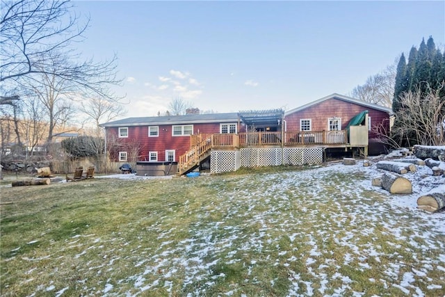 snow covered rear of property with a pergola, a wooden deck, and a hot tub