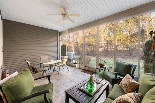 sunroom / solarium featuring ceiling fan