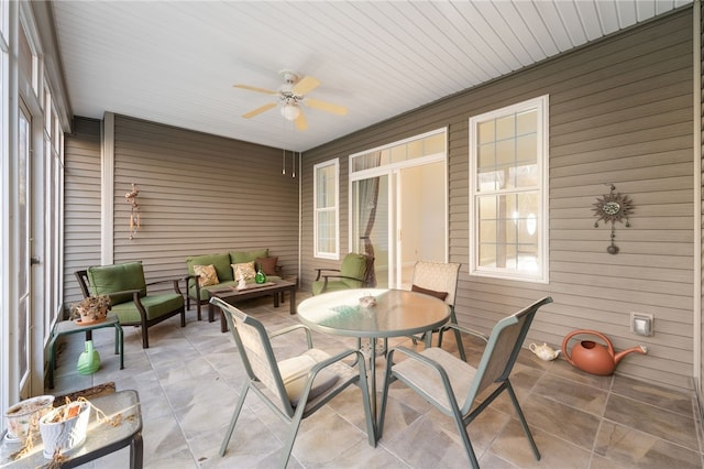 sunroom / solarium featuring ceiling fan