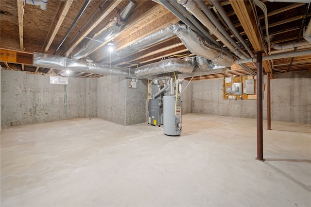 basement with electric panel, heating unit, and water heater