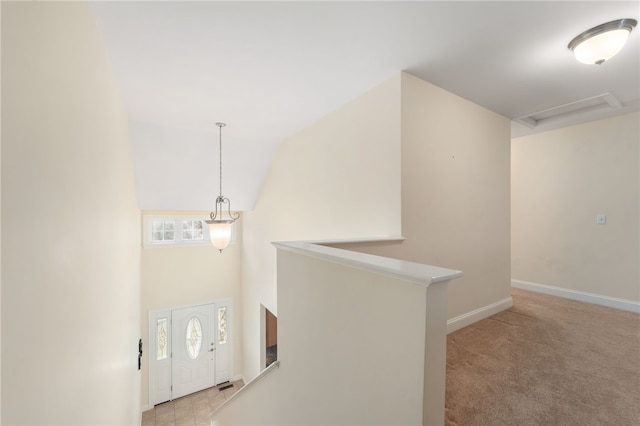 interior space featuring light carpet, lofted ceiling, and a wealth of natural light