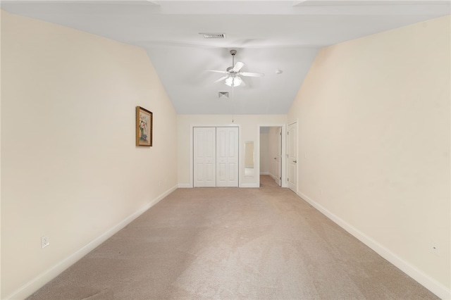 unfurnished bedroom with lofted ceiling, light colored carpet, and ceiling fan