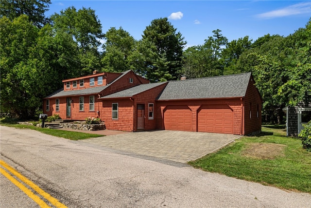 log cabin featuring a garage and a front yard