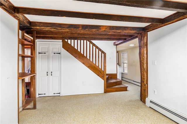 basement featuring a baseboard radiator and carpet floors