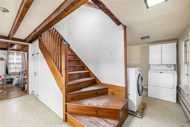 stairs with beamed ceiling, a baseboard radiator, and separate washer and dryer