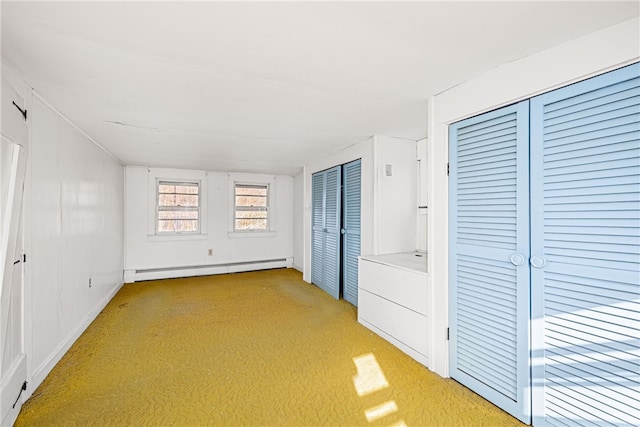 interior space with a baseboard radiator and light colored carpet