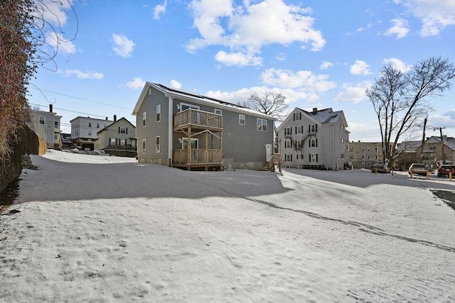 back of property featuring a balcony