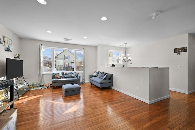 living room featuring a notable chandelier and wood-type flooring