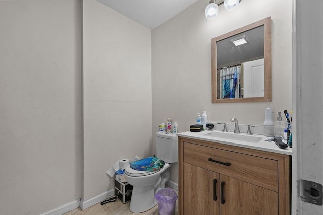 bathroom featuring toilet, tile patterned flooring, and vanity