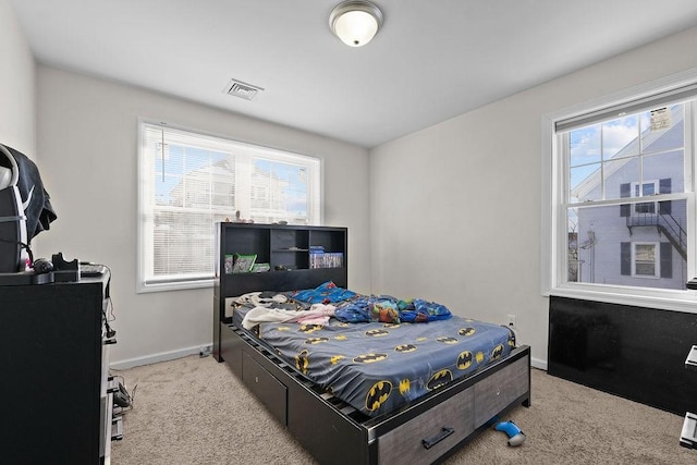 bedroom with light colored carpet