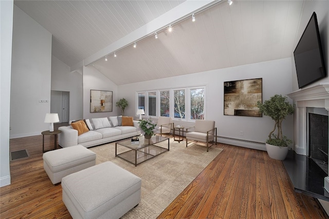 living area with visible vents, high vaulted ceiling, hardwood / wood-style floors, a fireplace, and baseboards