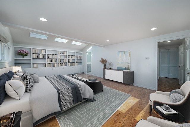 bedroom featuring hardwood / wood-style flooring and a skylight