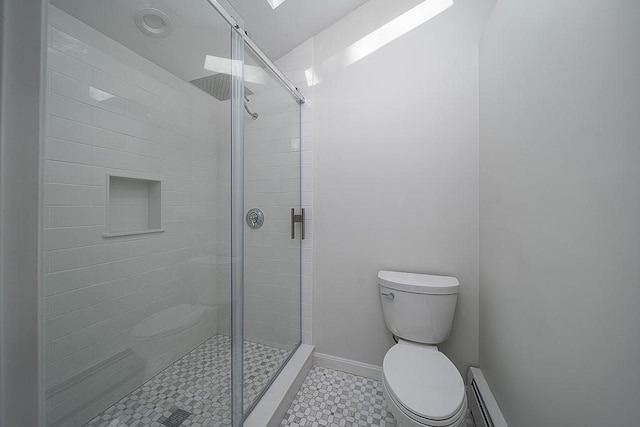 full bath with a stall shower, toilet, a baseboard heating unit, and baseboards