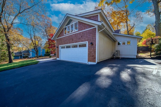 view of side of home featuring aphalt driveway