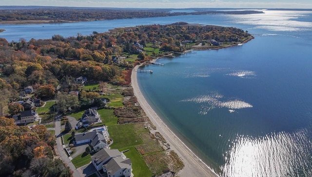 drone / aerial view with a forest view and a water view