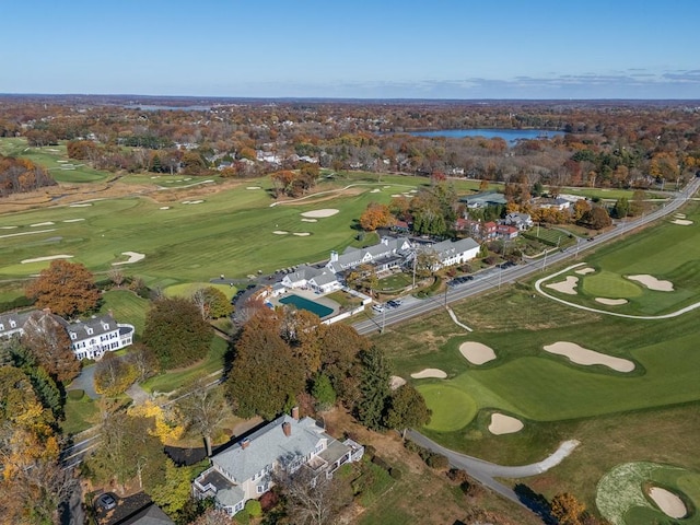 drone / aerial view with a water view and view of golf course