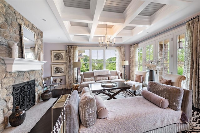 bedroom with coffered ceiling, an inviting chandelier, hardwood / wood-style flooring, beamed ceiling, and a fireplace