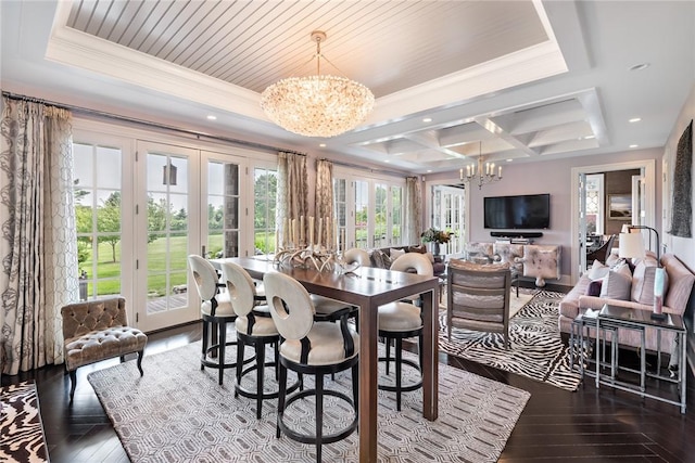 dining room with coffered ceiling, a notable chandelier, and a healthy amount of sunlight