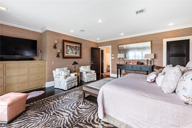 bedroom featuring hardwood / wood-style floors and crown molding