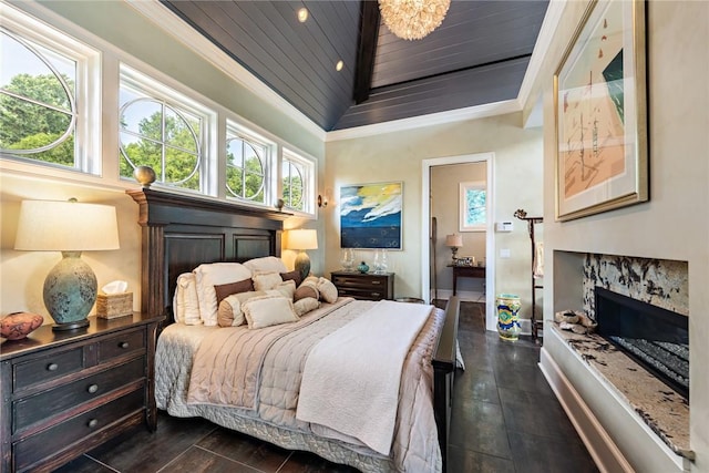 bedroom with a premium fireplace, vaulted ceiling, ornamental molding, and wooden ceiling