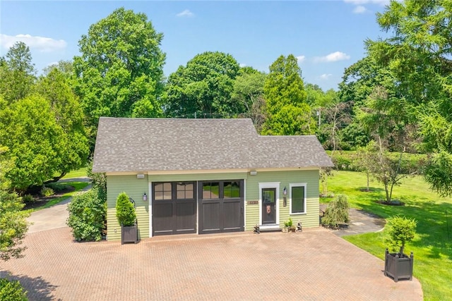 exterior space with a garage and a front lawn