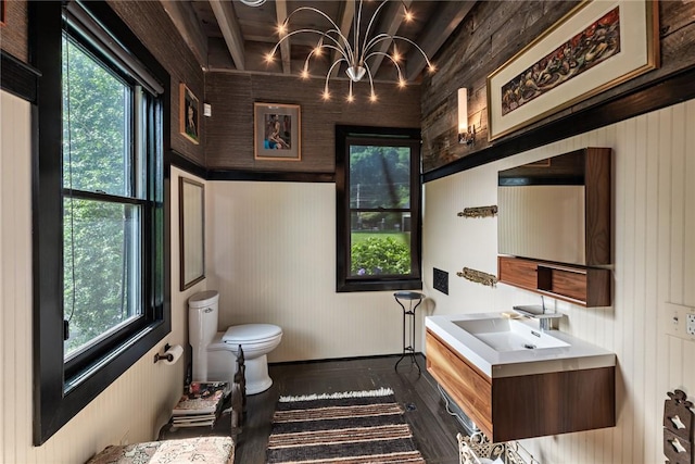 bathroom with hardwood / wood-style flooring and wooden walls