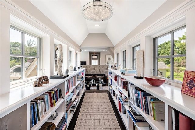 interior space featuring lofted ceiling and an inviting chandelier