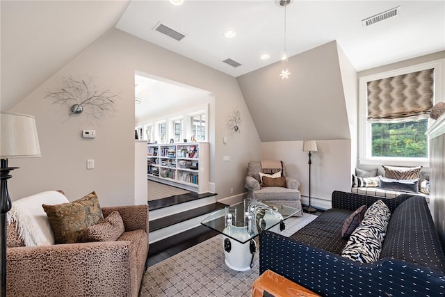 living room with hardwood / wood-style flooring, lofted ceiling, and a baseboard heating unit