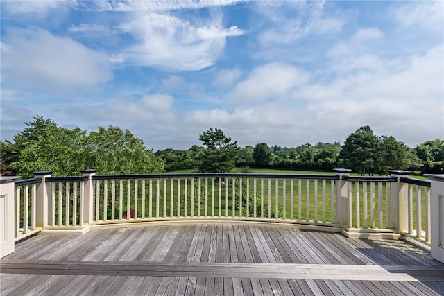 wooden terrace featuring a yard