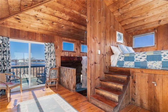 interior space with hardwood / wood-style flooring, wooden ceiling, lofted ceiling, and wood walls