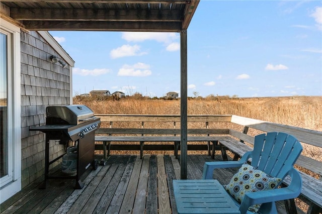 wooden deck featuring a grill