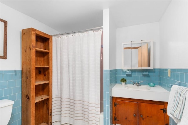 full bathroom with vanity, toilet, shower / tub combo, and tile walls